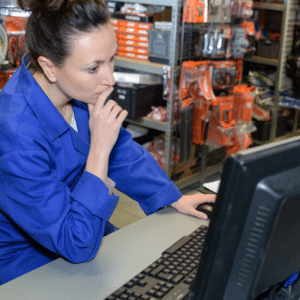 automotive shop worker helping customer with battery inventory